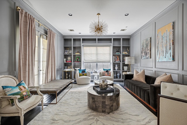 sitting room featuring crown molding and built in features