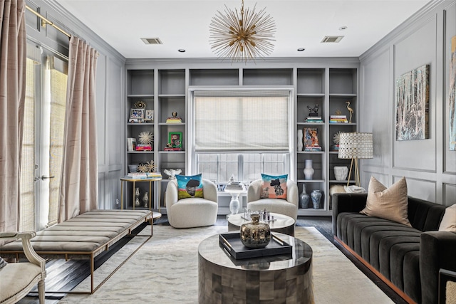 sitting room featuring ornamental molding and a healthy amount of sunlight