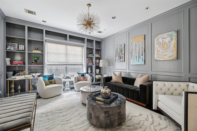 living room featuring built in shelves and ornamental molding