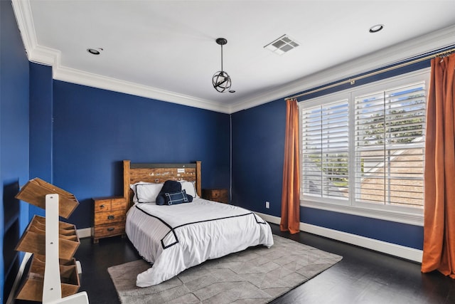 bedroom with crown molding and dark hardwood / wood-style floors