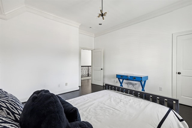 bedroom featuring an inviting chandelier, ornamental molding, and dark hardwood / wood-style flooring