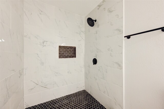 bathroom with a tile shower