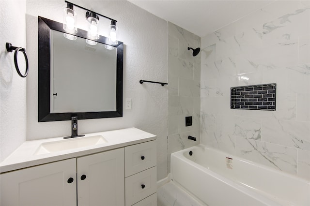 bathroom featuring vanity and tiled shower / bath combo