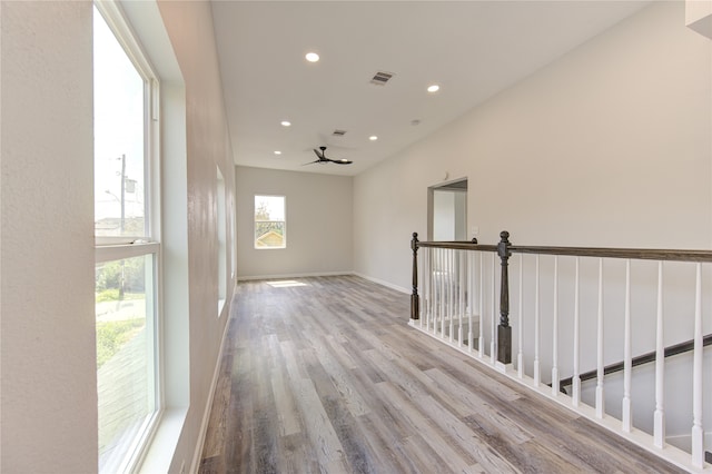 corridor with light hardwood / wood-style flooring