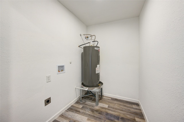 clothes washing area featuring washer hookup, water heater, dark hardwood / wood-style floors, and hookup for an electric dryer