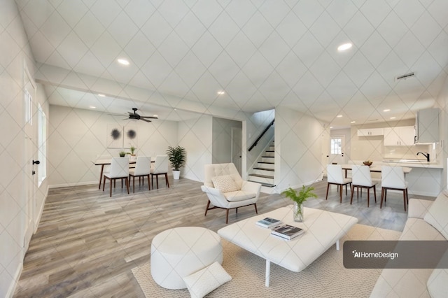 living room with ceiling fan and light hardwood / wood-style floors