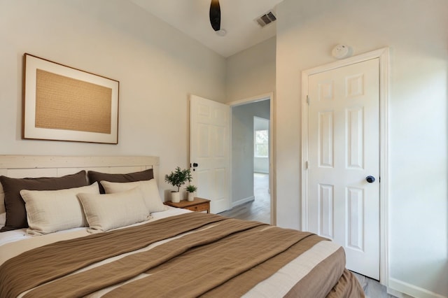 bedroom with wood-type flooring and ceiling fan