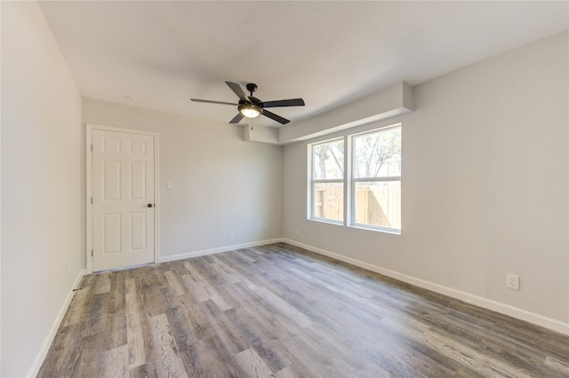 empty room with ceiling fan and light wood-type flooring