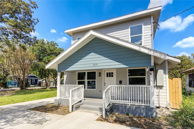 bungalow-style home with a porch and a front yard