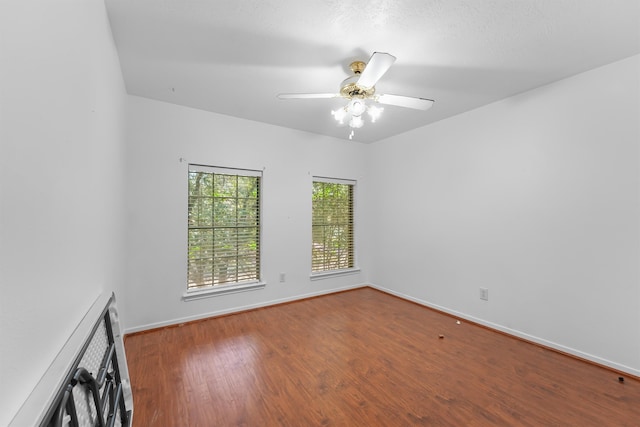 unfurnished room featuring ceiling fan and hardwood / wood-style flooring