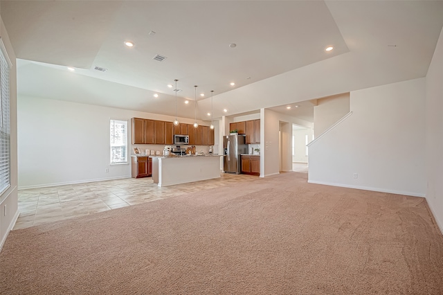 unfurnished living room featuring light carpet