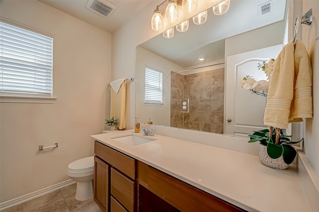 bathroom featuring toilet, vanity, and tile patterned floors