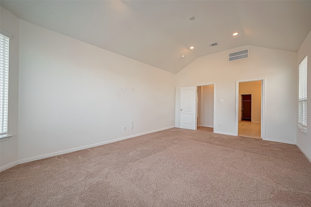 unfurnished bedroom with light carpet and lofted ceiling