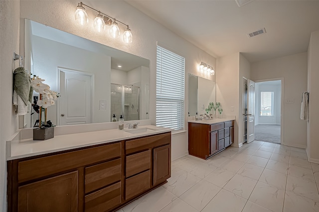 bathroom featuring vanity and a shower with shower door