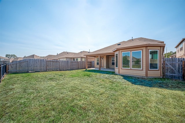 rear view of property with a patio and a yard