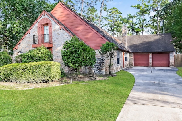 view of front of home featuring a front yard, brick siding, a garage, and concrete driveway
