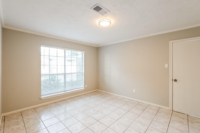 spare room featuring visible vents, baseboards, and ornamental molding