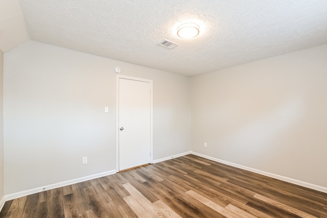 unfurnished room featuring a textured ceiling and wood-type flooring