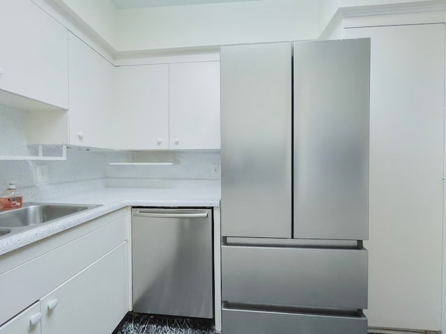 kitchen with white cabinets and appliances with stainless steel finishes