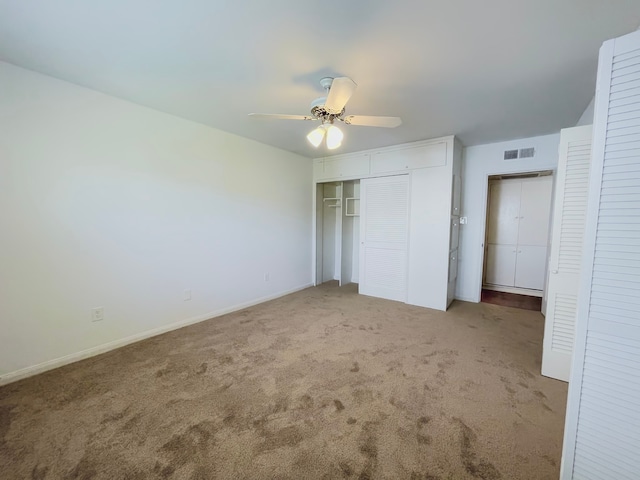 unfurnished bedroom featuring a closet, ceiling fan, and light colored carpet