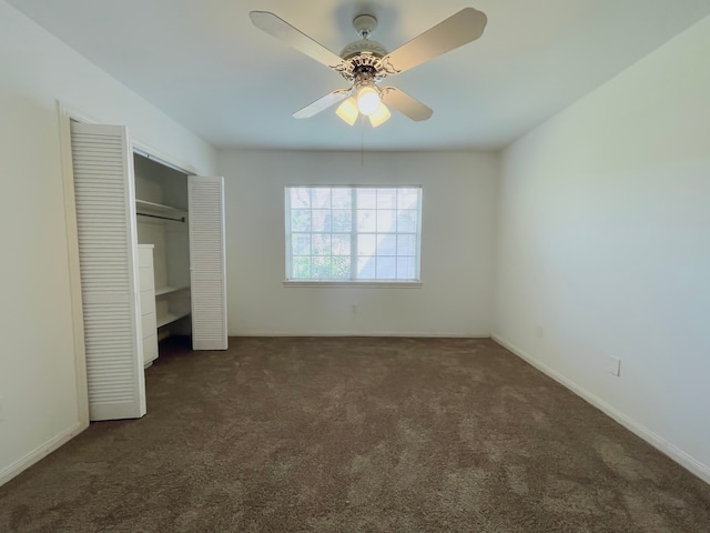 unfurnished bedroom featuring dark carpet, a closet, and ceiling fan