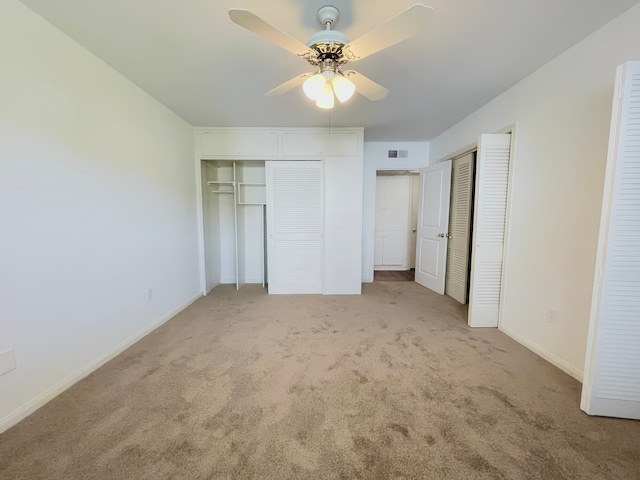 unfurnished bedroom with ceiling fan and light carpet