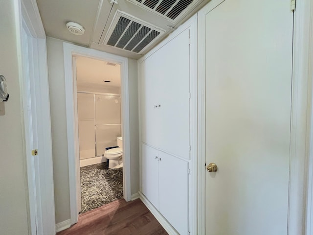 corridor with dark hardwood / wood-style flooring