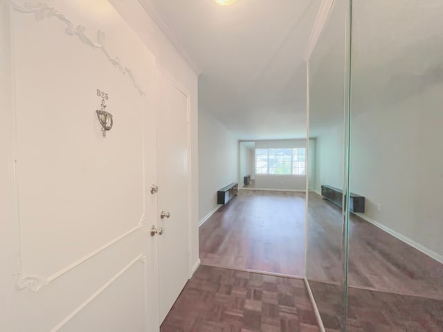 hallway featuring dark parquet floors and crown molding