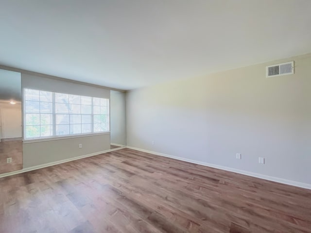 empty room with hardwood / wood-style flooring