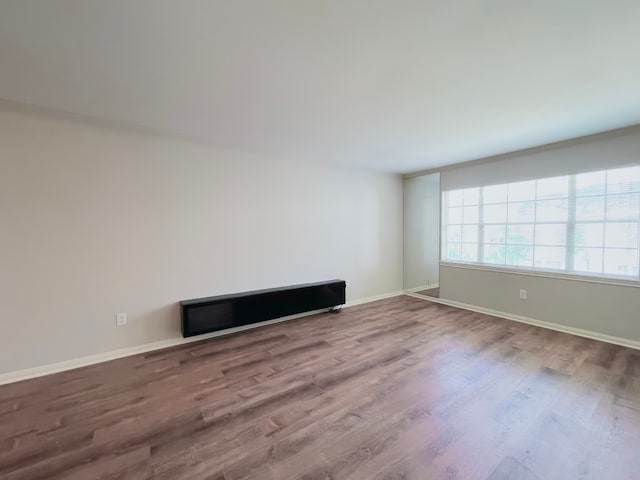 unfurnished room with wood-type flooring