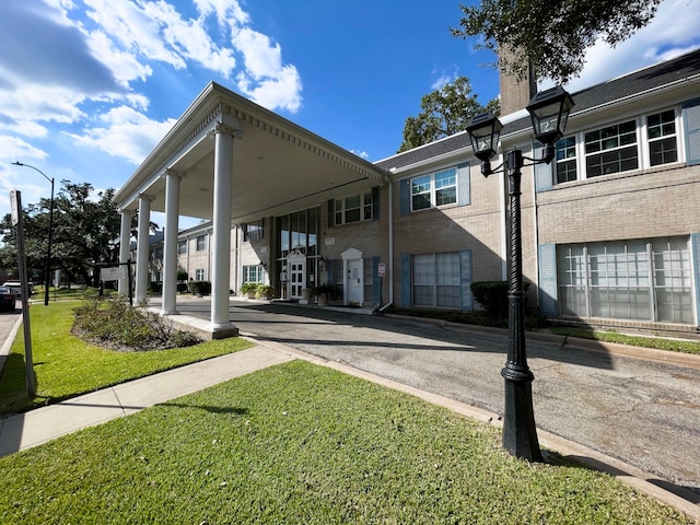 back of property featuring a lawn