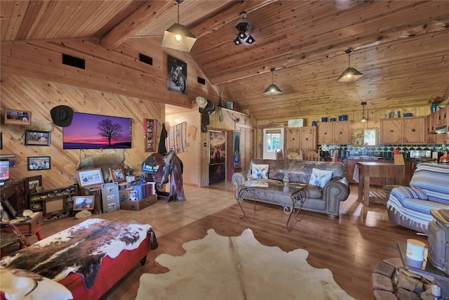 living room with beamed ceiling, wood ceiling, wooden walls, high vaulted ceiling, and light hardwood / wood-style floors