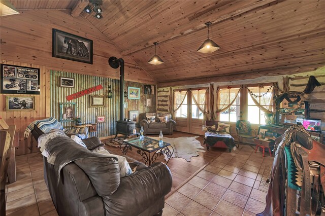 tiled living room with lofted ceiling with beams, wood walls, a wood stove, and wooden ceiling