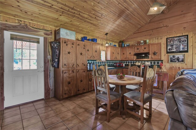 tiled dining room featuring high vaulted ceiling, wood walls, and wooden ceiling