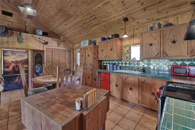 kitchen featuring decorative backsplash, wood walls, vaulted ceiling, and light tile patterned floors