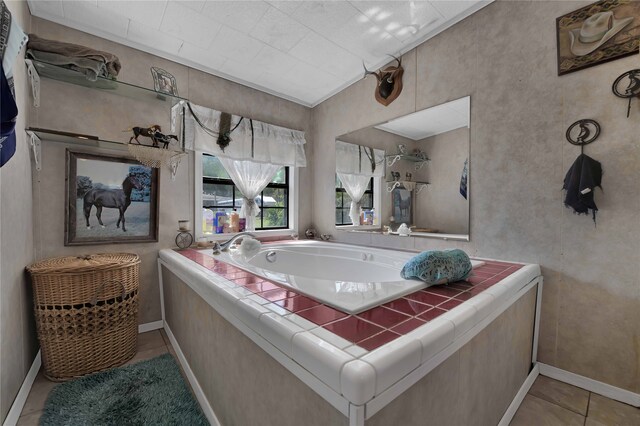 bathroom with a bathtub and tile patterned floors