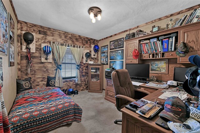 carpeted bedroom with wood walls and a textured ceiling