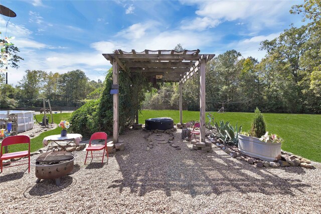 view of yard with a pergola and a fire pit