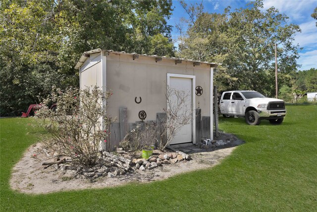 view of outdoor structure with a lawn