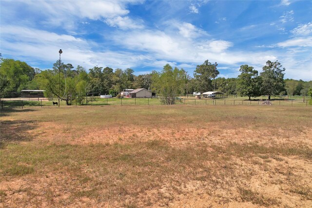 view of yard with a rural view