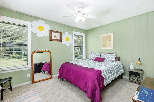 bedroom with ceiling fan, carpet, and multiple windows