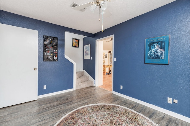 empty room with ceiling fan and hardwood / wood-style floors