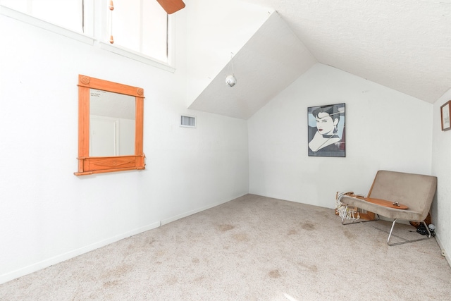 additional living space with vaulted ceiling, ceiling fan, and light carpet