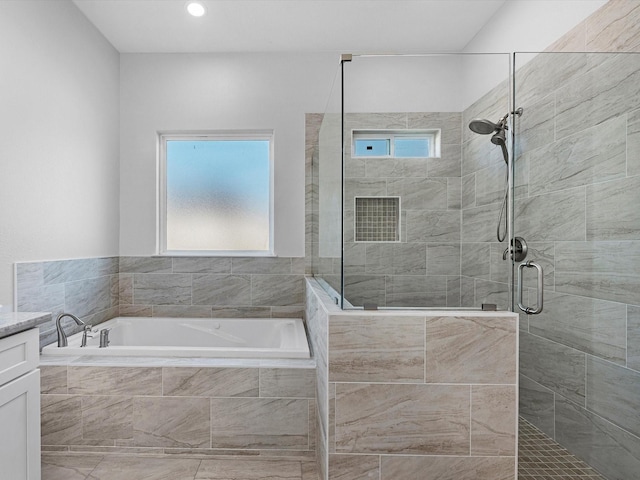 bathroom with vanity and separate shower and tub