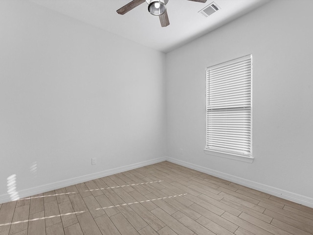 spare room with ceiling fan and light wood-type flooring