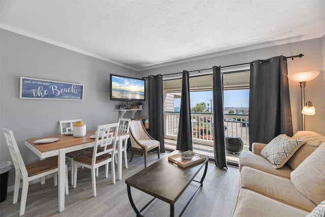6102 Seawall Blvd Unit 294, Galveston, TX 77551 - living area with a textured ceiling, ornamental molding, and wood finished floors