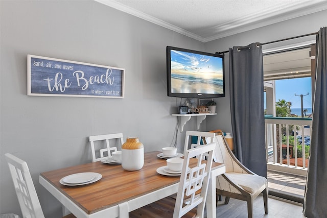 6102 Seawall Blvd Unit 294, Galveston, TX 77551 - dining room with ornamental molding, wood finished floors, and a textured ceiling
