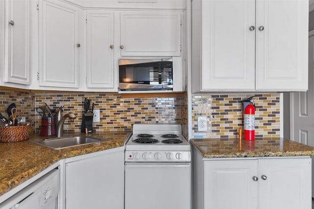 kitchen featuring white appliances, white cabinetry, backsplash, and a sink