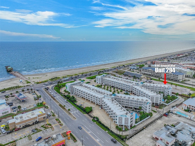 birds eye view of property with a city view, a water view, and a beach view