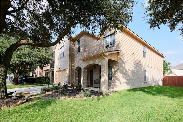 view of front of home featuring a front yard and a garage